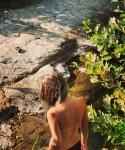 Bareback girl at a swimming hole in Myrsonas river near Agios Polikarpos Ikaria island, Greece
